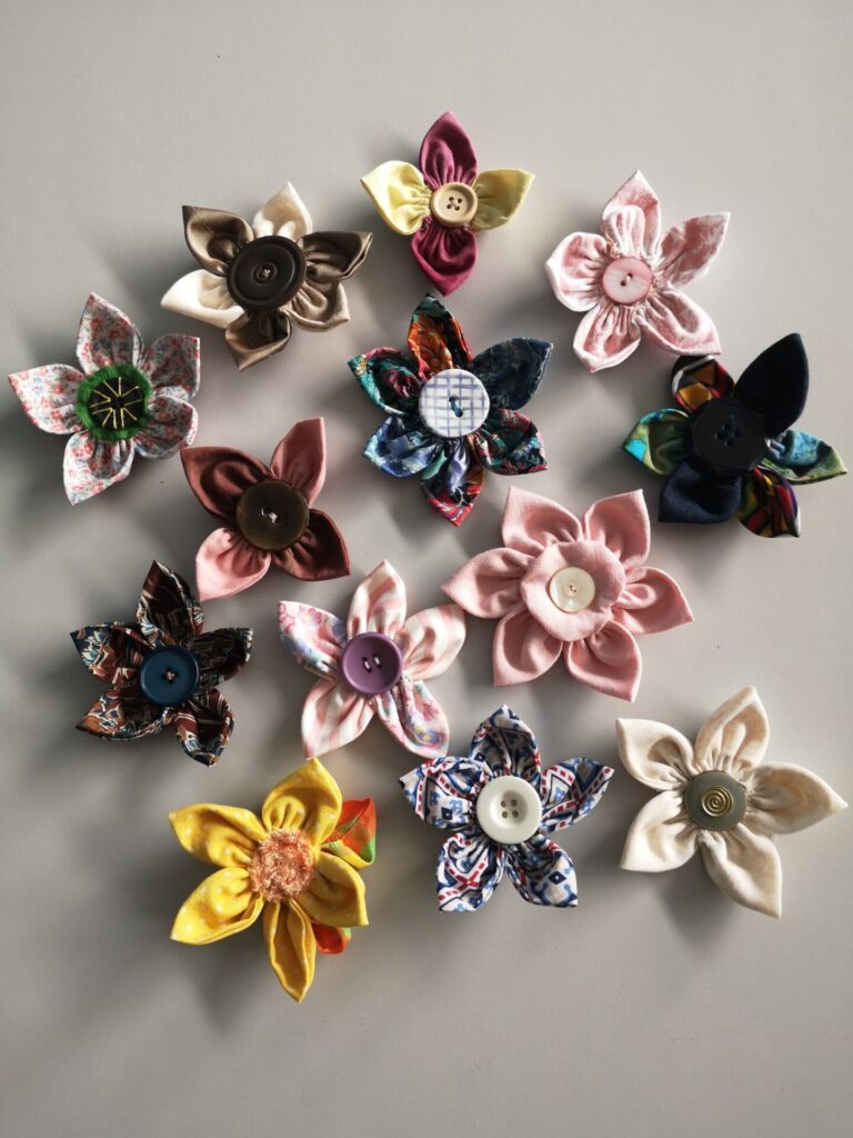 A display of crafted items - flowers with buttons at the centre.