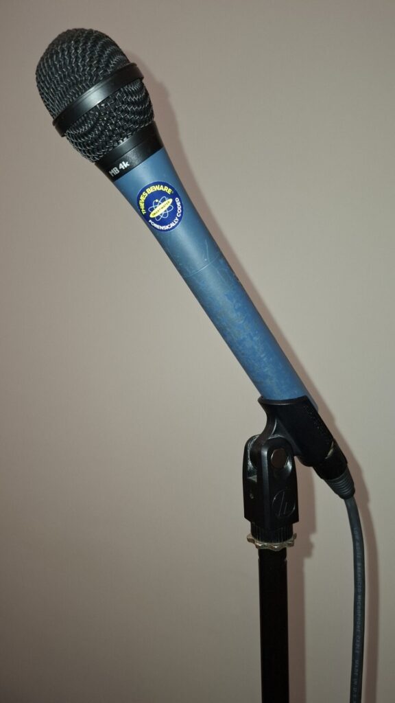 A stage microphone with no one holding it.