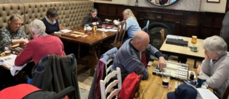 People playing backgammon in a pub.