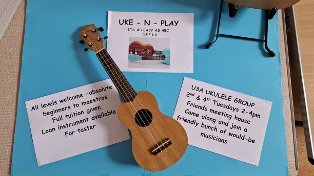 A small ukulele with material advertising the group meetings