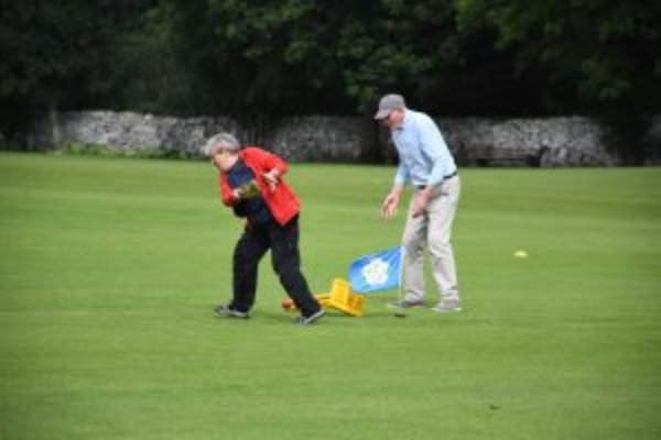 Two people playing walking cricket